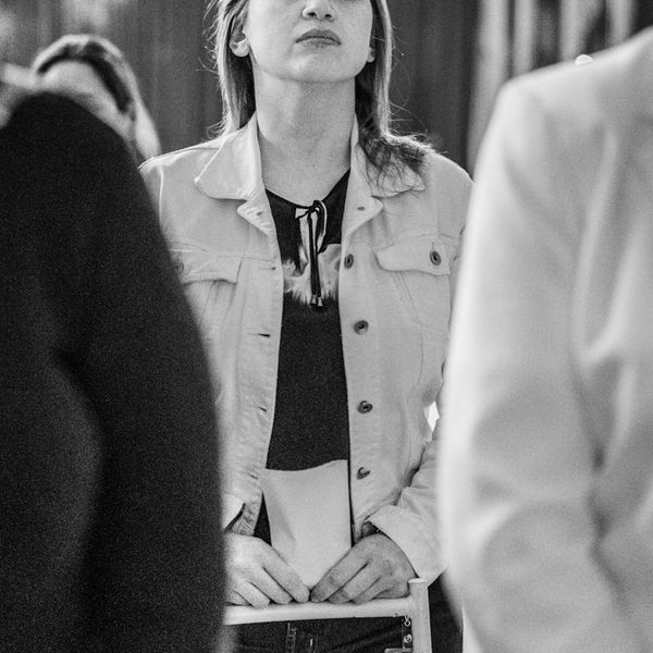 Calm woman with closed eyes focusing inwards in a serene environment.